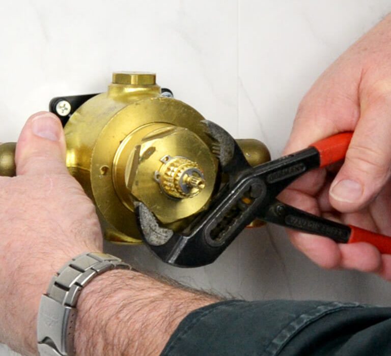 Engineer servicing a mixer shower
